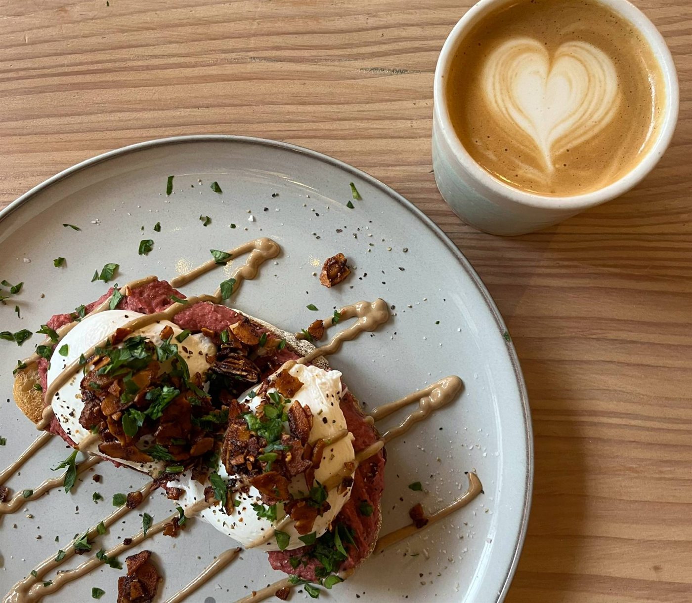 A savoury cafe plate served beside a latte